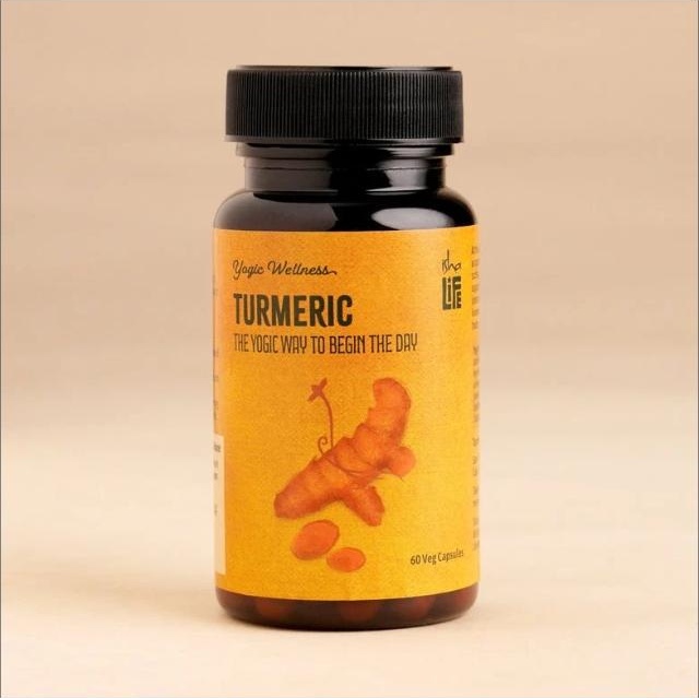 Isha Life Turmeric capsules bottle with turmeric root illustration on label